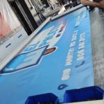 Blue printed vinyl banner on the production table at Xenix Graphics