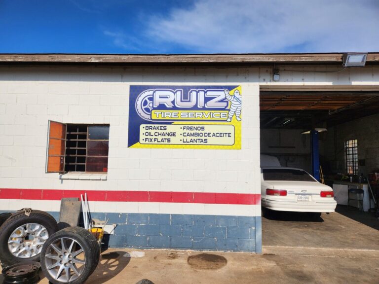 Custom outdoor business sign mounted on an auto shop building, made by Xenix Graphics