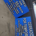 Blue bilingual Closed For The Season / Cerrado Por Temporada signs by Xenix Graphics