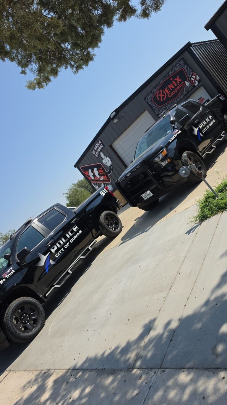 Two City of Dumas police trucks with lettering by Xenix Graphics